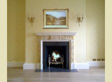 A Hallidays hand carved pine mantelpiece, painted with a marble paint effect